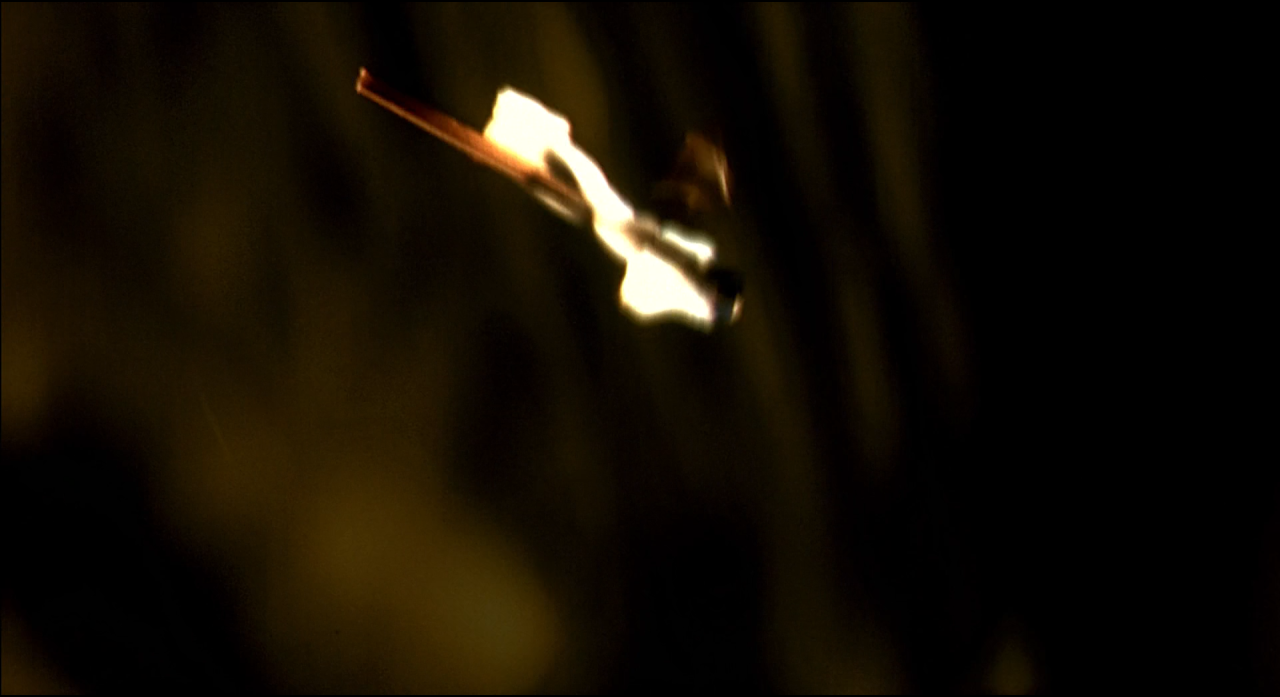 A small bright streak suspended in an otherwise nearly black frame.